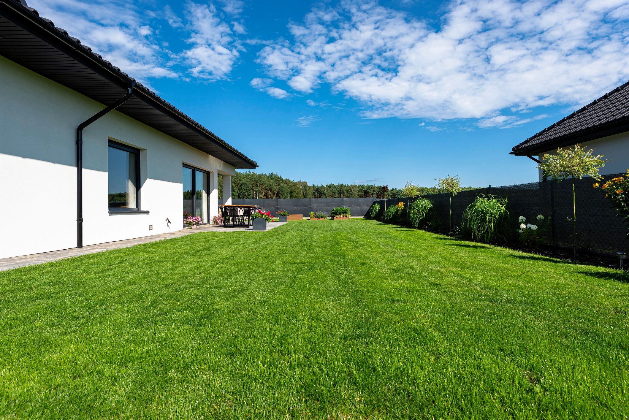Luxury custom home exterior with landscaped lawn